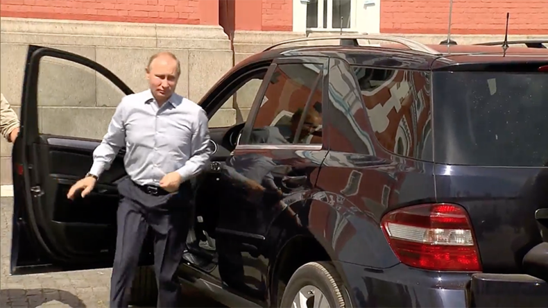 'Who's that passenger Putin is driving?' President's arrival at Russian monastery causes media hype