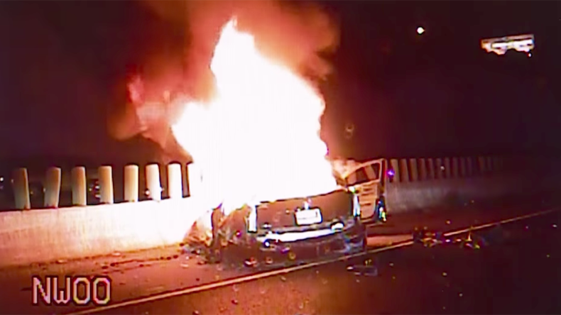 Cops drag couple from blazing wreckage after car plunges off bridge (VIDEO)