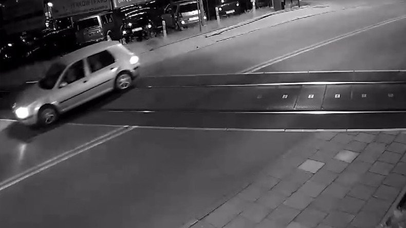 Car misses train by seconds after crashing through crossing barrier (VIDEO)