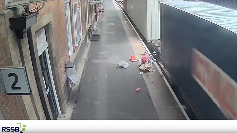 Stroller wiped out by freight train after rolling away from mother (VIDEO)