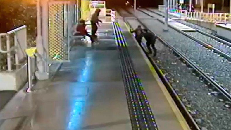 Horrific CCTV footage shows man drop-kicked off train platform (VIDEO)