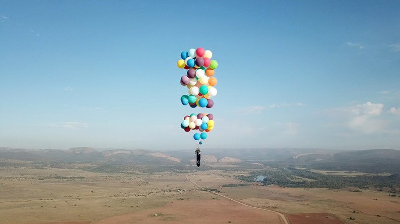 Daredevil dangles from deckchair tied to helium balloons 8,000ft above Africa (VIDEOS)