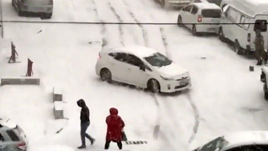 Skid row! Cars slide down slippery slope, slamming into others after heavy snowfall (VIDEO)