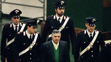Mafia boss, Toto Riina escorted by Carabinieri (Military Police) arriving in court at Palermo's Ucciardone prison in 1993 for trial. Reuters