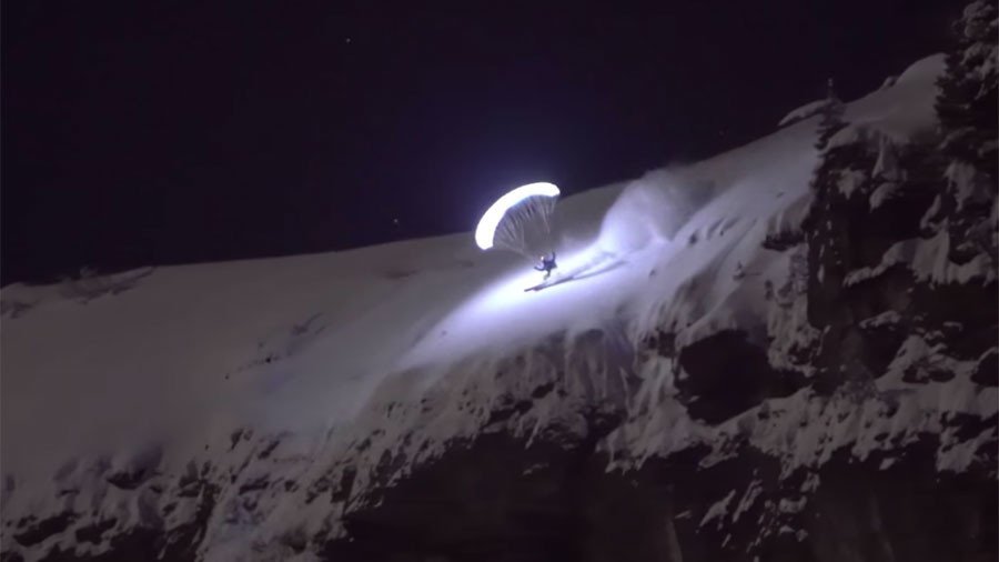 ‘Moonlighting’ daredevil skis & flies across glacier in night-time stunt  (VIDEO)