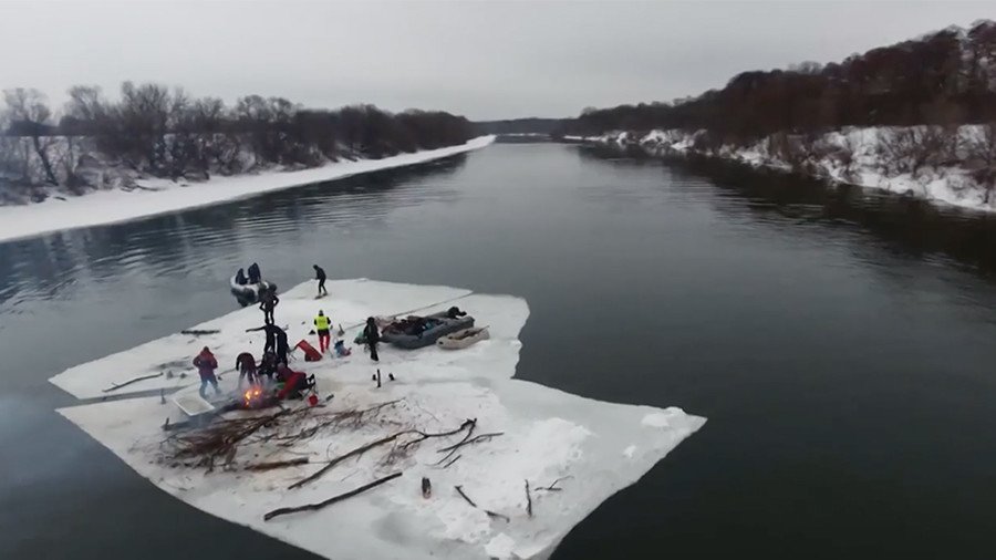 Party like a Russian: Friends saw off massive chunk of ice & sail down a river (VIDEO)