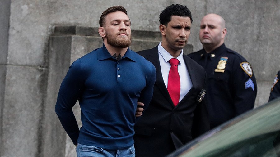Conor McGregor emerges from jail in handcuffs after UFC 223 bus frenzy (VIDEO)