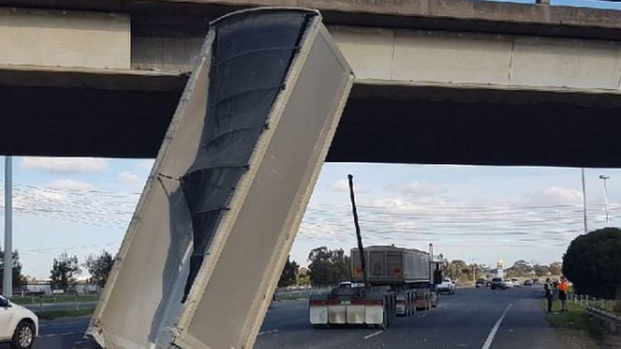 Barely-believable highway collision sees dump truck plow into bridge (VIDEO)