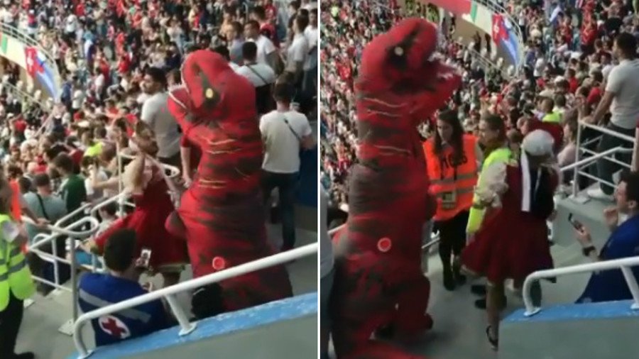 Surreal scenes as dinosaur & man in dress fight at Costa Rica v Switzerland (VIDEO)