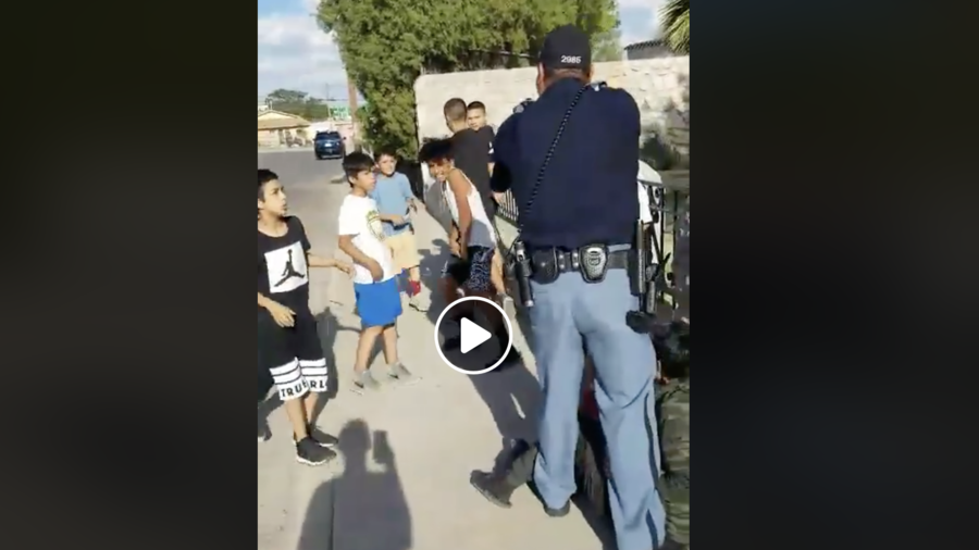 ‘Why is he picking on little kids?’ Footage shows cop pointing gun at children 