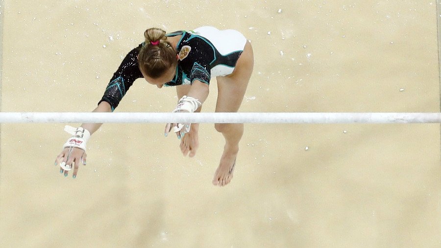Russian gymnast slams onto her back after falling 8ft from bars, emerges unscathed (VIDEO)
