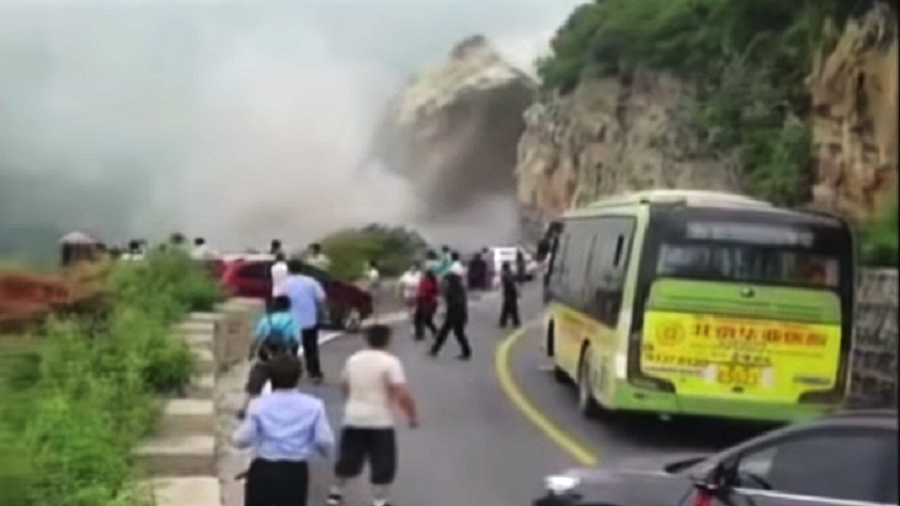 'Not a hero, that's just my job': Chinese man stops traffic as huge landslide hits road (VIDEO)