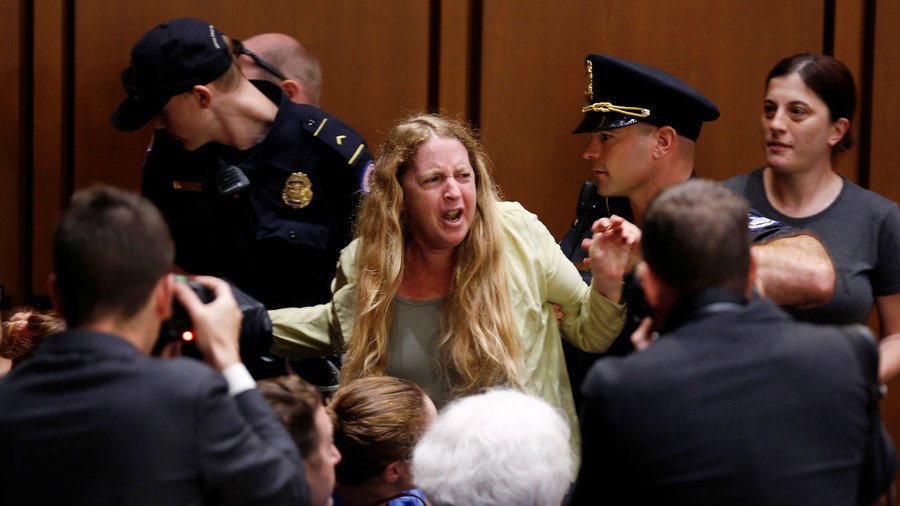 Paid protesters at Kavanaugh hearings? Twitter abuzz after photo shows activist receiving cash