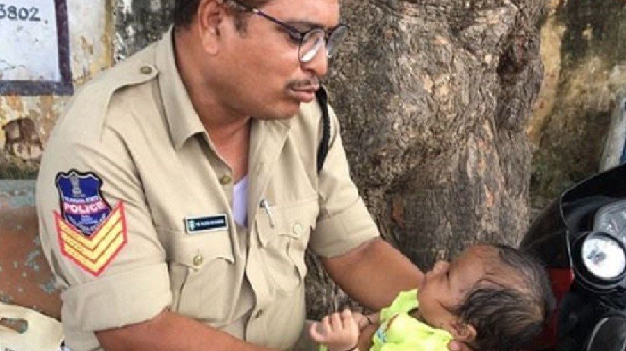 Viral IMAGE of Indian officer consoling baby while mom sits police exam wins hearts