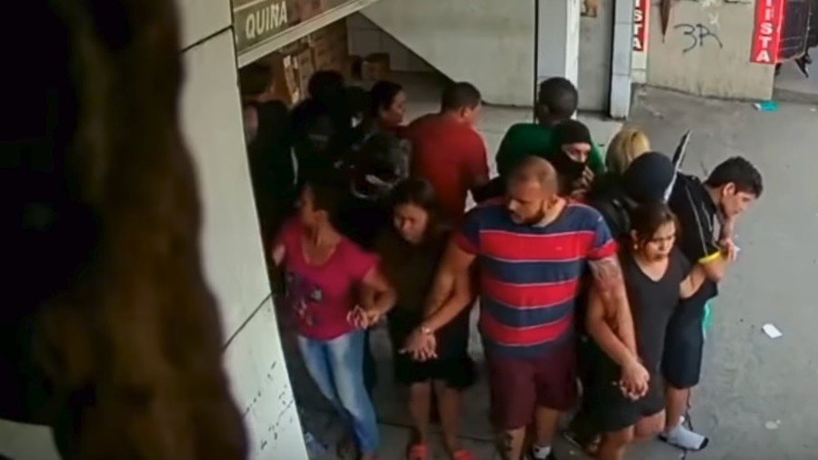 WATCH moment armed robbers break into lottery shop in Brazil, use 25 hostages as human shields 