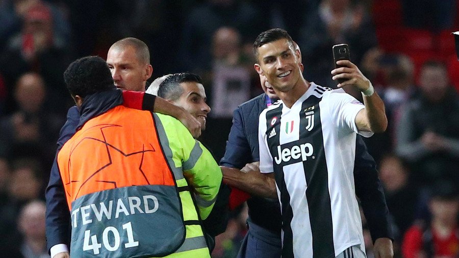 Football selfie of the year? Security-restrained pitch invader snags snap with Ronaldo! (PHOTOS)