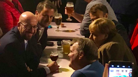 Driven to drink? Merkel, Macron and other EU leaders enjoy beers and fries after Brexit talks