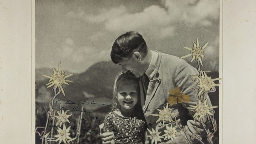 ‘Fuehrer’s child’: Stunning photo of Hitler hugging Jewish girl goes on sale in US (VIDEO)