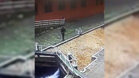 Heads up! CCTV captures distracted man walking straight into canal (VIDEO)