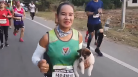 Puppy love: Marathon runner carries dog 19 miles after finding it lost on route (VIDEO)