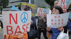 Japan’s Abe says US military base to be relocated regardless of referendum results