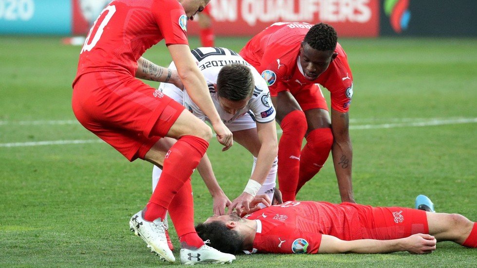 Concern as Swiss footballer plays on despite being knocked unconscious ...