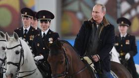 Putin rides horse (this time fully clothed) alongside mounted female police officers (VIDEO)