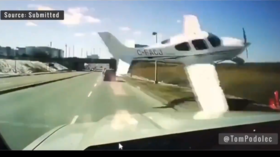 WATCH: Plane scrapes along highway inches from truck before crashing near airport 