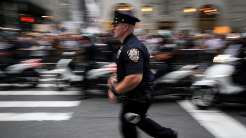 полицейские бегут за подозреваемым по оживленной улице