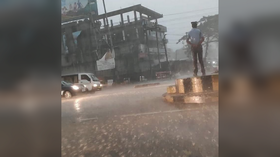 Indian traffic cop showered with praise for manning post during torrential rainstorm (VIDEO)