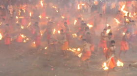Fight fire with fire: Hundreds of Indian men try to set each other ablaze to appease goddess (VIDEO)
