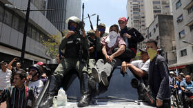 Caracas warns it'll use weapons if needed as crowds of coup supporters flock to presidential palace