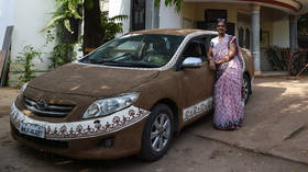 ‘Toyota Cow-rolla’: Indian woman plasters her car with bovine DUNG to cool it down (PHOTOS)