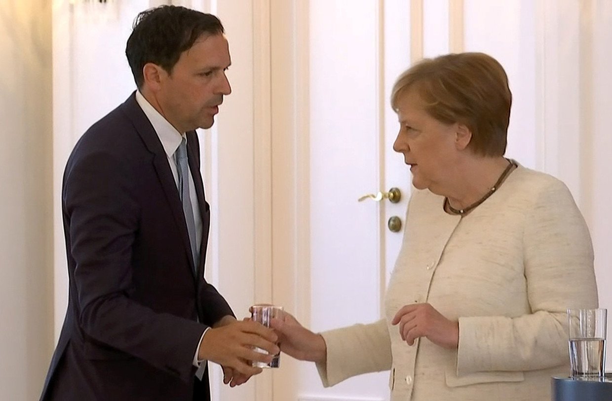 Angela Merkel receives water as she was seen shaking © REUTERS TV