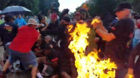 July 4 protesters toss burning US flag at Secret Service officer, clash with pro-Trump demo (VIDEO)