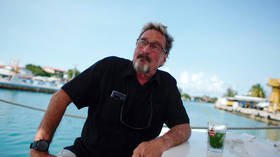 McAfee claims CIA tried to ‘collect’ him, poses armed in boat with his wife (PHOTO)