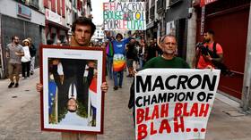 Hundreds protest Macron’s climate policies, carrying STOLEN portraits of him upside-down