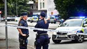 Woman shot dead after masked gunmen open fire on Swedish beach