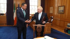 ‘Do I throw it over him?’: Priest hands Irish PM heading to meet BoJo bottle of HOLY WATER ‘for protection’ (VIDEO)