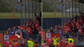 Football player catches, then drinks, flying beer hurled by fan during goal celebration (VIDEO)