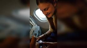 WATCH exclusive VIDEO & PHOTOS of Russian gun activist Maria Butina inside Moscow-bound plane
