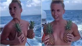 Feeling fruity: Russian ice hockey host leaves little to the imagination as she parties topless with pineapples (VIDEO)