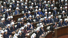 Safety first: Japanese MPs practice putting on foldable helmets in earthquake drill (VIDEO)