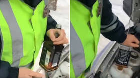 Traffic cops pour WHISKEY in patrol car instead of antifreeze in viral VIDEO... then insist it’s a Christmas prank