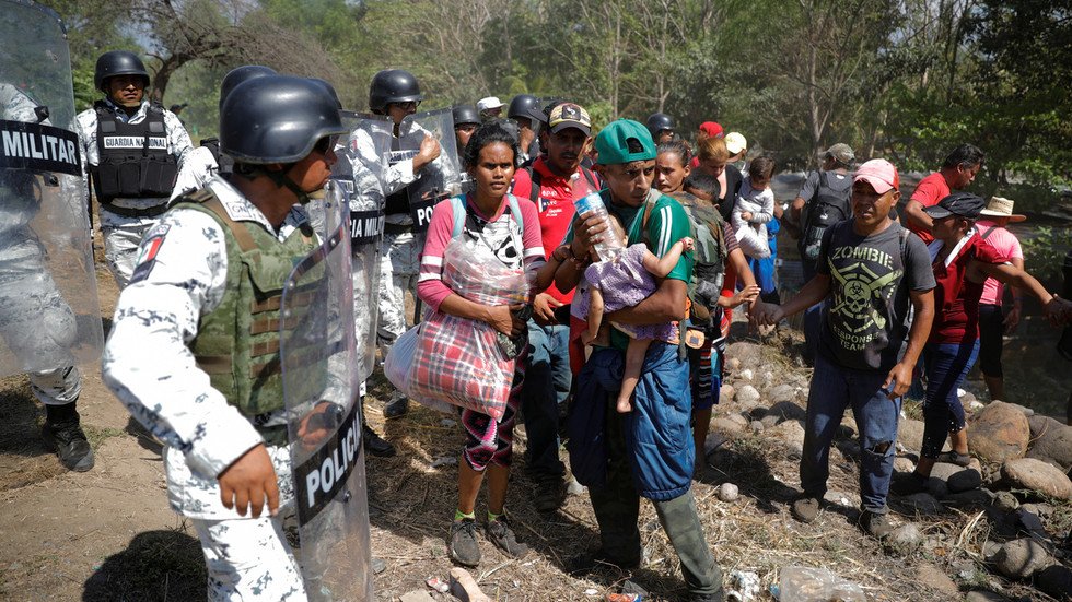 US-bound migrants cross into Mexico through river, hurl stones at ...