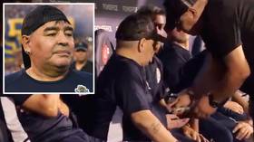 Maradona handed mystery package on the bench as coaches appear to block cameras during match (VIDEO)