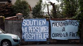 ‘Political repression’: Woman detained by police in France for displaying ‘Macronavirus’ banner on garden wall