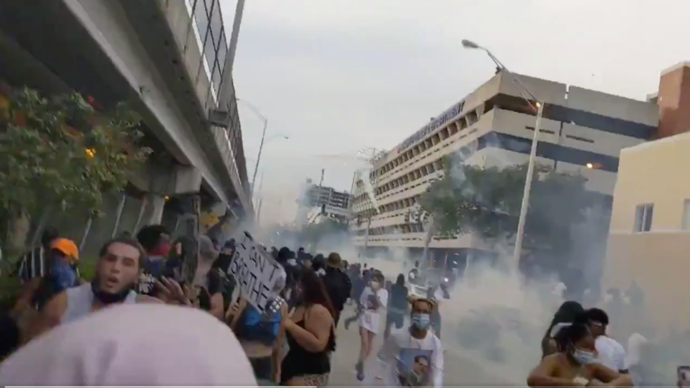 Riot police fire tear gas at protesters outside Miami Police Department ...