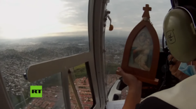 Virgin Mary image flown on HELICOPTER over Ecuador’s Covid-19 hotspot as families struggle to bury the dead