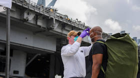 US sailors return to coronavirus-hit aircraft carrier only to test positive AGAIN, despite months of containment efforts